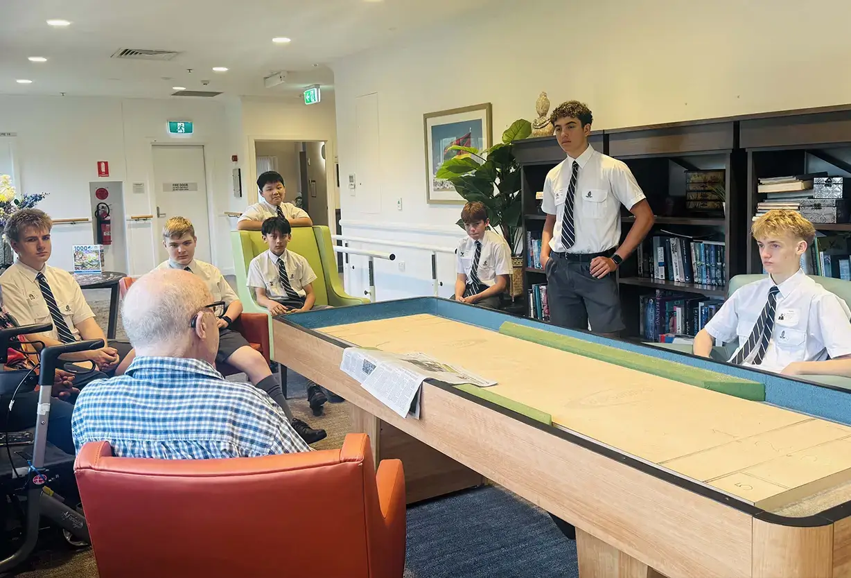 Shore School students visiting an aged care facility as part of a community engagement service learning programme.