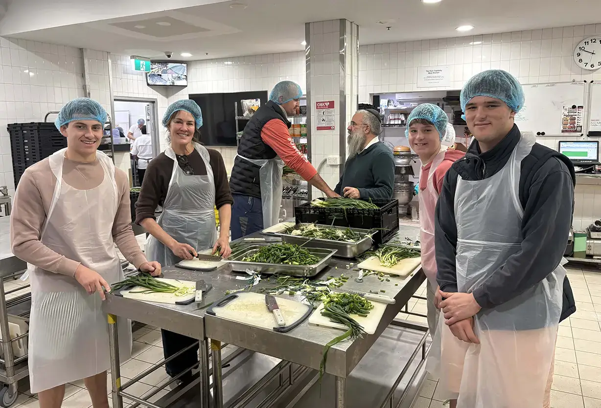 Shore School students volunteering at Our Big Kitchen and preparing meals for community support programmes.